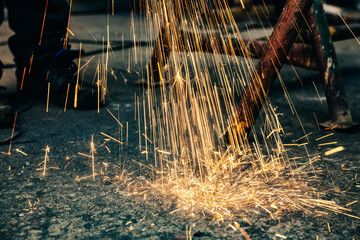 Sparks from grinder in factory.