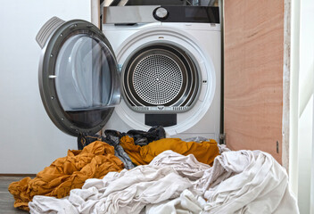 Laundry flowing out of washing machine and tumble dryer