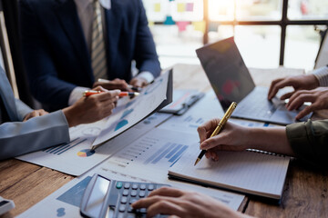 Teamwork process. Business people pointing at business document during discussion at meeting.