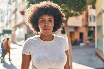 African american woman standing with serious expression at street