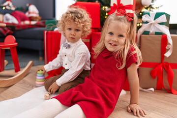 Adorable boy and girl smiling confident celebrating christmas at home