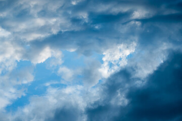 white clouds in a blue sky, lots of clouds before the rain