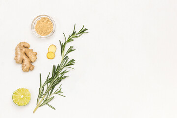 Ginger, rosemary sprig and lime. Alternative cold and flu remedy.