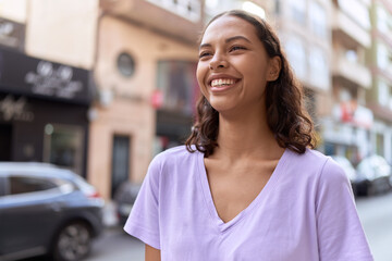 Young african american woman smiling confident looking to the side at street