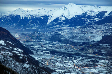 snow covered Rhone valley, the city of Sion and mountains in the Swiss Alps