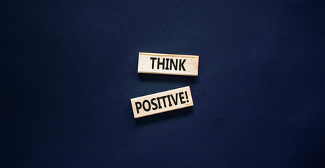Think positive symbol. Concept words Think positive on beautiful wooden block. Beautiful black...