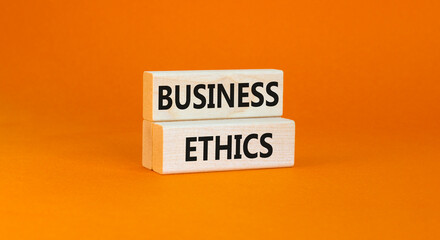 Business ethics symbol. Concept words Business ethics on beautiful wooden blocks. Beautiful orange table orange background. Business ethics concept. Copy space.