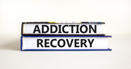 Addiction recovery symbol. Concept words Addiction recovery on beautiful books. Beautiful white table white background. Psychology addiction recovery concept. Copy space.