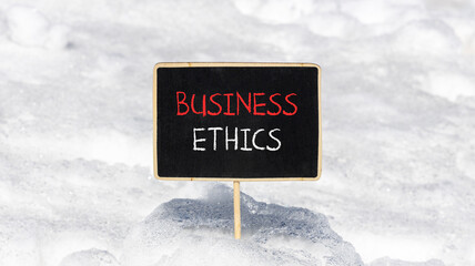 Business ethics symbol. Concept words Business ethics on beautiful black chalk blackboard....
