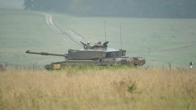 British army Challenger 2 II FV4034 main battle tank reversing and stopping, commander and gunner directing action on a military exercise. Wilts UK