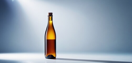  a bottle of beer sitting on a table with a spotlight on the side of the bottle and a light on the top of the bottle.