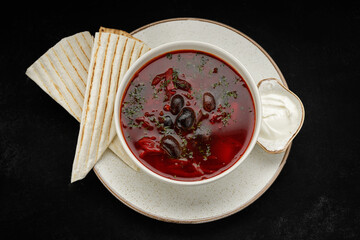 Red borscht with beans, sour cream and pita bread