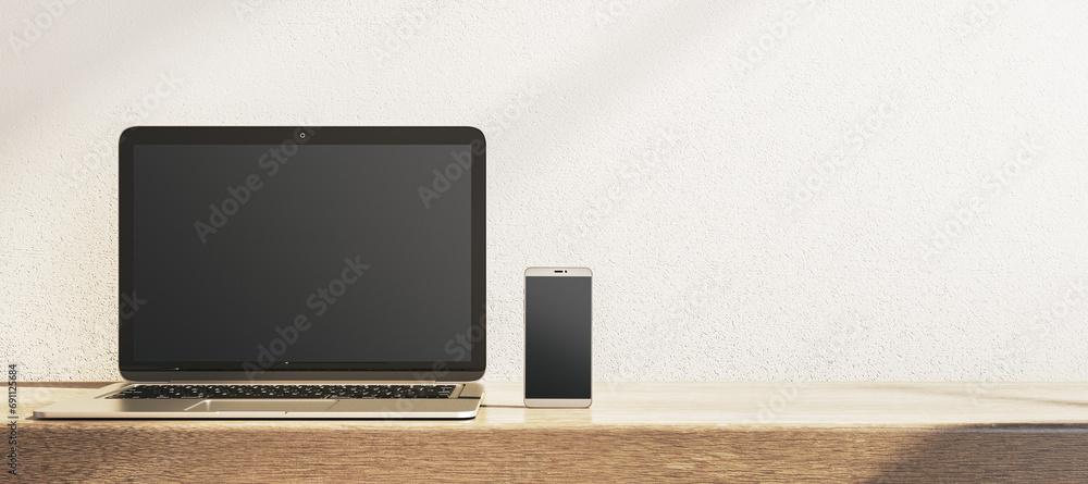 Poster close up of empty laptop and smartphone on wide wooden desk. concrete wall background. device presen