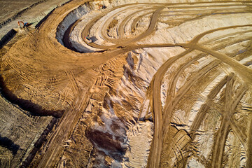 Aerial view of the patterns of roads on a sand quarry. Extraction of construction sand in a large...