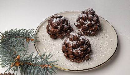Christmas tree cone shaped cookies with chocolate flakes with powdered sugar, a delightful homemade dessert for the New Year. a chocolate pine cone-shaped shortbread cookies with sweet snow, rotation