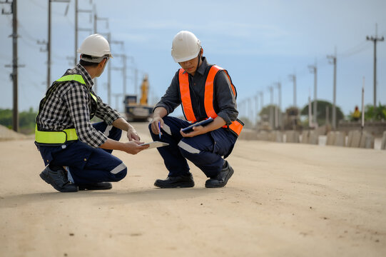 Highway engineers discuss plans for construction improvement based on roadworks. Soil Fill, Backfill Compaction for Sub base, Base Course, Surveyor Engineer inspector in highway construction.