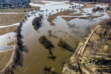 Aerial view of an overflowing river and flooded fields during spring floods