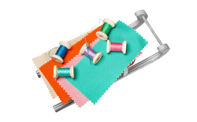 set of colored threads on wooden spools