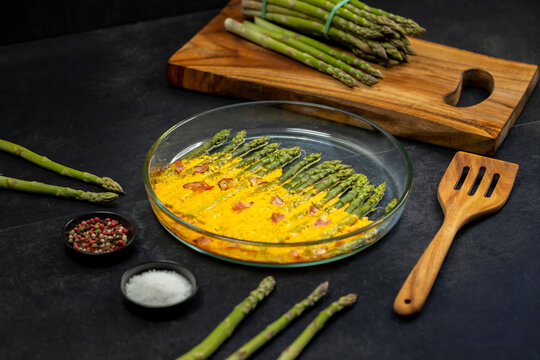 green asparagus baked with chedar cheese and parma ham