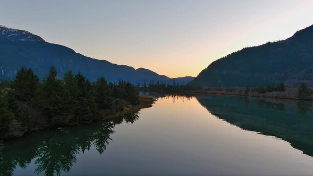 Lake surrounded by Mountains and Trees in Canadian Nature. Fall Season, Sunset Sky. Squamish, British Columbia Canada.