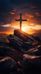 Christian cross in the top of a mountain at sunset.