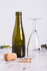 Sober January concept, text, glass, bottle and cork on the table vertical view