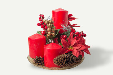 centerpiece with red candles and pine cones and poinsettia isolated on white background