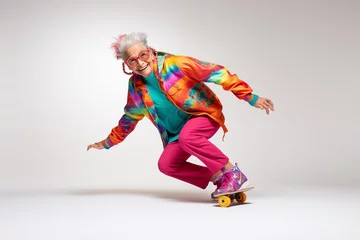 Rollo Mature funny older woman with wrinkled face in colorful clothes on skateboard isolated in white background, An energetic happy grandmother on skateboard, playful funky poses of an adult woman skating © Ishra