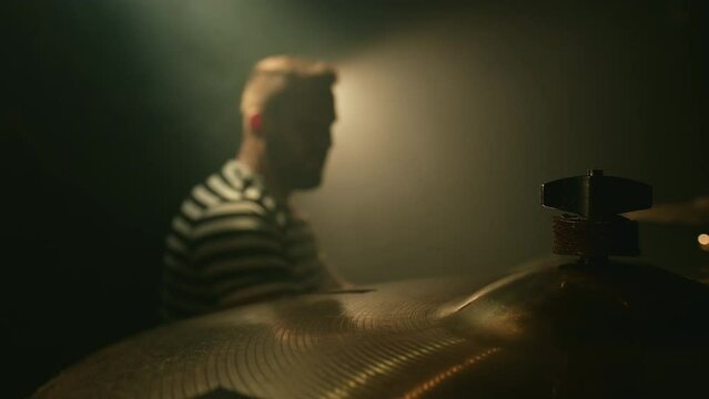 Drummer hits drum plate. Drummer rehearsing on drums in a studio. Close-up