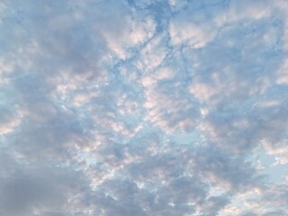 Cloudy sky with light blue and pink colors during sunset