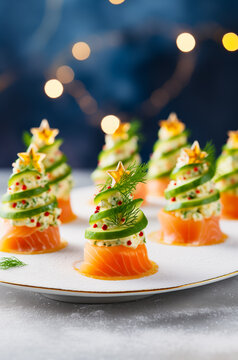 Adorable Festive salmon cucumber canapes in shape of Christmas trees. Vertical, side view, close-up.