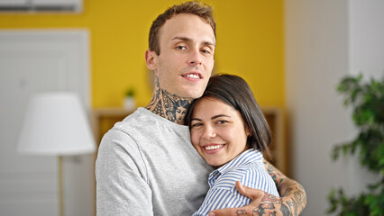 Obraz premium Beautiful couple smiling confident hugging each other kissing at home