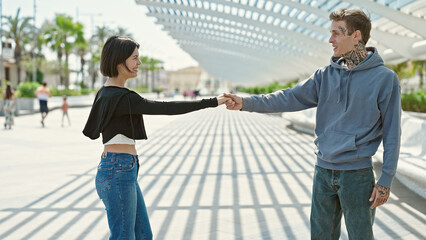 Beautiful couple smiling confident dancing at park