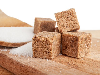 refined sugar cubes from sugar toast, brown sugar on wooden plate, sweet background close