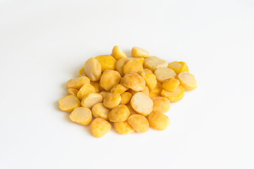 Heap of yellow split chickpeas on white background