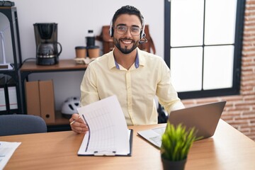 Young arab man call center agent smiling confident working at office