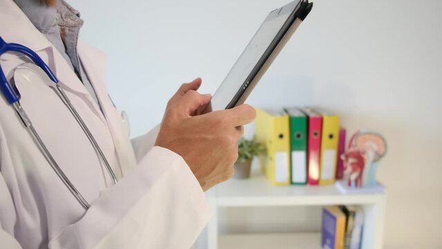 Witness a hospital doctor utilizing a tablet to review a neuroimage, meticulously exploring test results. Immerse yourself in the realm of clinical medical care, neuroimaging, and the vital interplay