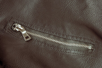 Jacket made of black leather fabric natural with modern fasteners selective focus
