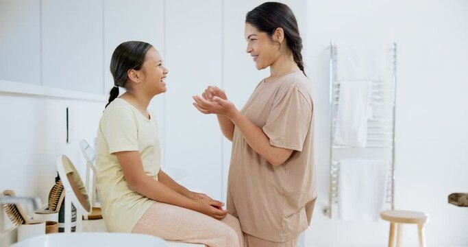 Skincare, beauty and mother with child in bathroom for facial cream, lotion or spf at home. Dermatology, cosmetic and young mom helping girl kid with face routine or treatment in modern house.