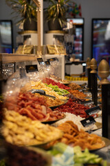 Luxury stand of a dried fruit store. Vertical image of a commercial store display full of bowls with sweet products.