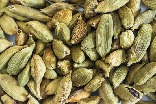 Close-up detail and texture of whole green cardamom pods, top view