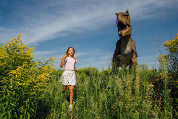 Beautiful girl running from dinosaur