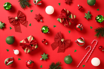 Christmas decorations, gift boxes, candy canes, baubles on red background