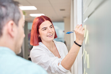 Business people meeting at office and use post it notes to writing strategy business plan to development to share idea grow to success . Brainstorming concept.