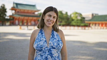 Beautiful hispanic woman, a radiant portrait of happiness and confidence, smiling and posing joyfully at traditional heian jingu in kyoto, japan, portraying carefree fun and success