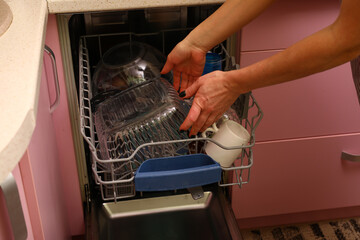 Loading dirty dishes into the dishwasher on the kitchen