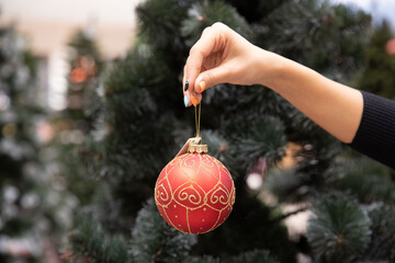Close-up of vintage decorative ball on the branch of Christmas tree.
