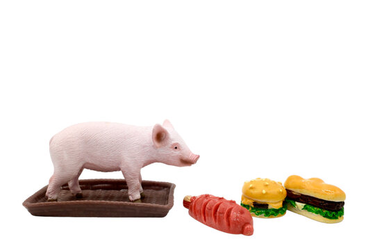 miniature figurine of a pig on a tray with some fast food sandwiches