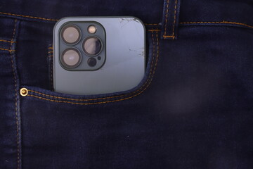Broked cellphone in a jeans pocket. Phone with case broked in the jeans pocket 