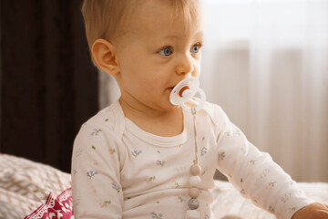 baby sucking a pacifier